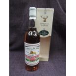 A bottle of Gordon and Macphail George and J W Smith's 15 year old 57% vol Glenlivet whisky, pink