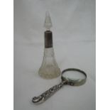 An Edwardian cut glass cone shaped perfume bottle having cut glass stopper and silver collar with