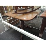 A 19th century mahogany pedestal table having rectangular flip top on bobbin column and triple