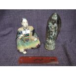 A vintage cast Japanese figure of Tempo design and a Japanese ceramic figure modelled as seated