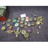 A collection of military badges and buttons, also other badges