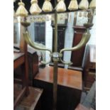 A mid 20th century brass standard lamp of scroll and reeded Empire design