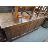 An 18th century oak kist/coffer having plank top and panel front on stile frame