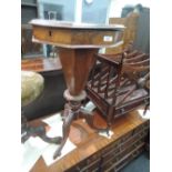 A mid Victorian walnut sewing table having octagonal lift top with fitted interior on tapered