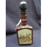 A leather covered decanter showing hunting scenes containing Spanish Napoleon Brandy