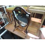 A 19th century mahogany toilet/swing mirror of Hepplewhite Shield design on shaped frame