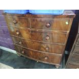 An early 19th century mahogany bow front chest of 2 short and 3 long cockbeaded drawers on later