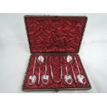 A cased set of Victorian silver teaspoons and matching sugar nips having shaped column stems and