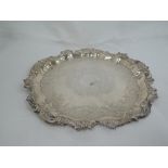 A silver salver having pie crust rim with moulded decoration, central engraving and commemorative