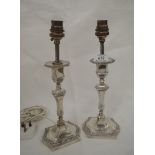 A pair of Edwardian silver candlesticks having been converted to lamps, the candlesticks being of