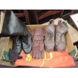 A military collection of leather gloves, flag, army boots and black leather knee length boots