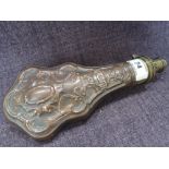 A vintage copper and brass powder flask having embossed pattern decoration