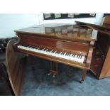 A vintage baby grand piano in mahogany case, labelled Steck