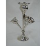 A small silver epergne having a central flute in form of a stylised poppy seed head with shaped rim,