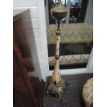 A Victorian brass and ceramic oil lamp base converted to standard lamp having embossed brass