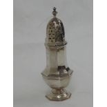 A silver sugar caster of octagonal form having facetted body and push on domed lid with pireced