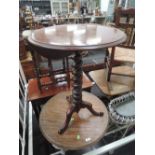 A 19th century mahogany pedestal table having circular rim top and twist column on triple splay