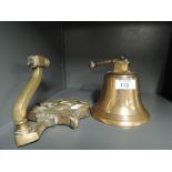 A vintage brass cast wall bracket and bell with HMS Victory of Trafalgar motiff