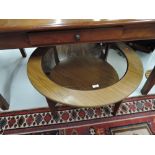 A vintage teak effect and glass circular coffee table