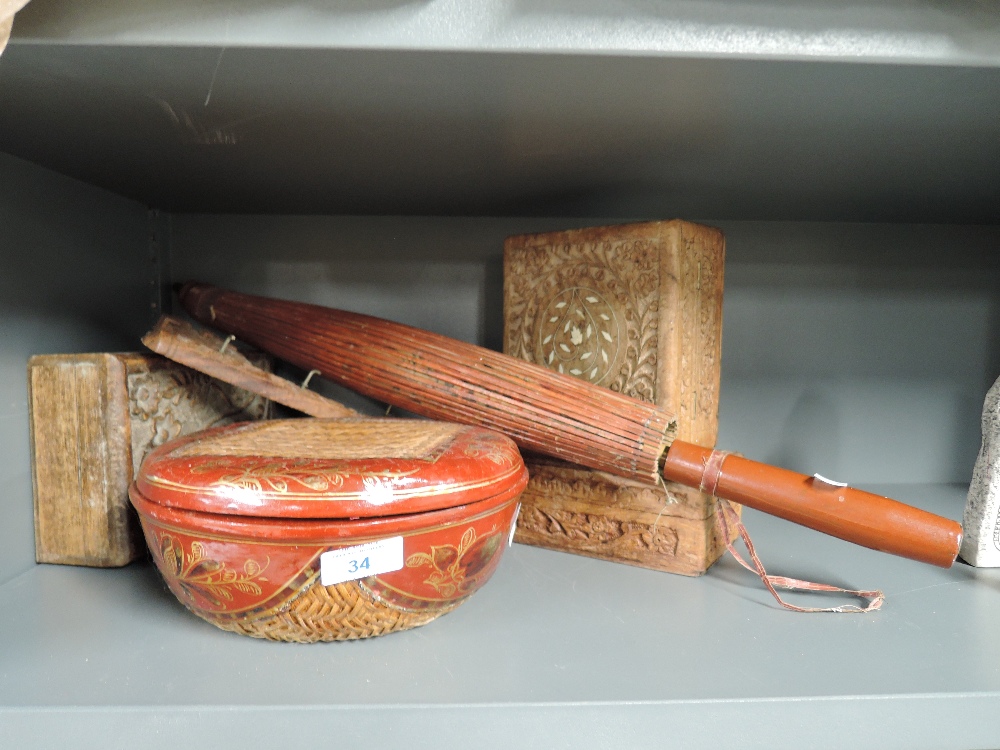 A selection of ethnic and oriental style carved and decorated wooden items