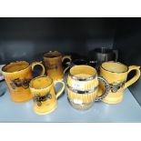 A selection of vintage ceramic mugs by Wade and J.H.Potter silver plate cream jug