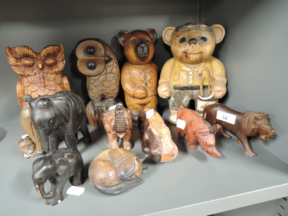 A large selection of wooden treen carved figures and figurines including African animals