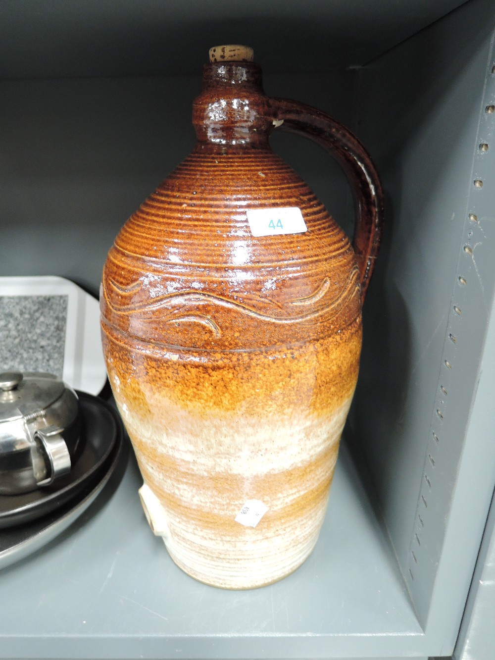 A large earthern ware salt glazed jug or decanter