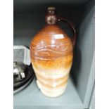 A large earthern ware salt glazed jug or decanter