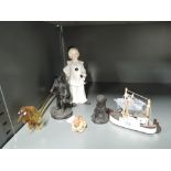A selection of decorative figurines including glass sausage dog