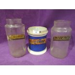 A selection of vintage apothecary medicine jars ceramic and glass with labels