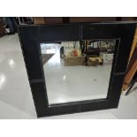 Two modern black leatherette framed mirrors