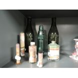 A selection of decorative sand art and vintage bottles