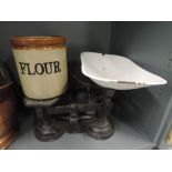 A vintage cast scale set and salt glazed flour jar