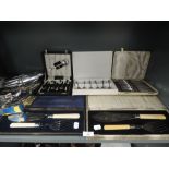 A selection of boxed flat wares and cutlery