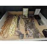 A selection of vintage costume jewellery including necklace and badges