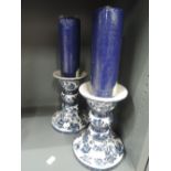 A pair of large standing ceramic candle sticks with transfer style print