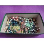 A box of modern costume jewellery including beads, enamelled pendant, hematite necklaces etc