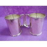 Two silver plated cylindrical tankards of plain form