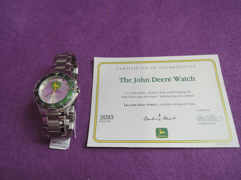 A Gents quartz John Deere wrist watch having a baton & dot dial to silvered face with logo and