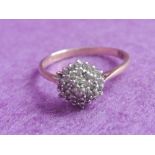 A lady's dress ring having a small diamond chip triple cluster, approx .25ct on a 9ct gold loop,