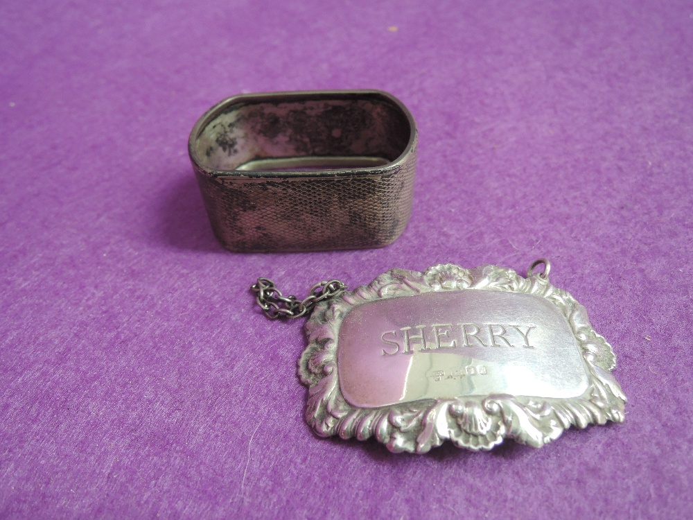 An HM silver Sherry decanter label and an HM silver napkin ring having engine turned decoration