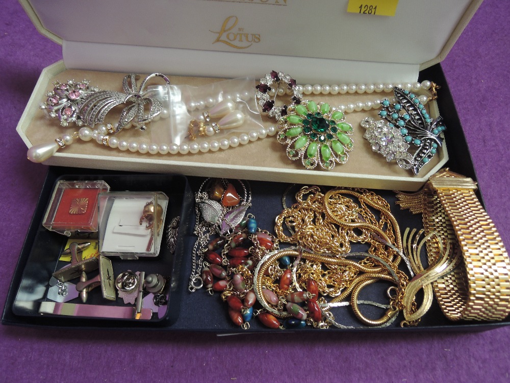 A selection of costume jewellery including brooches, chains, cufflinks etc