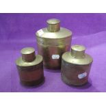 A set of vintage graduated copper canisters, impressed with size number to base