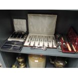 A selection of boxed flatware and cutlery, also some loose spoons and impressed serving items