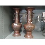 A pair of bronze effect cast vase with oriental style design work and sea horse form handles