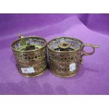 A pair of vintage brass chamberstick candle holders with pierced fret work