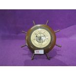 A vintage barometer "Lorioter" in the form of a ships wheel