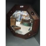 An Edwardian style hexagonal mirror with bevel edged glass