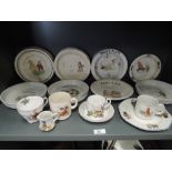 A selection of vintage baby plates cups saucers etc with transfer prints