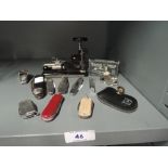 A selection of desktop items and trinkets including pen knifes and whistles